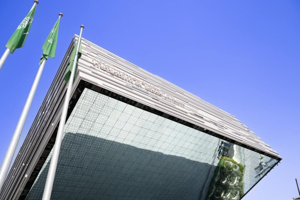 Low angle view of a modern building with flags in Dubai, UAE.
